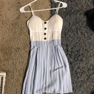 blue and white stripped dress with white at top and brown buttons